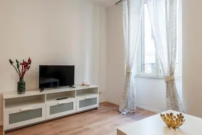 a living room with a tv on a dresser at Avignonesi 04 - FromHometoRome in Rome
