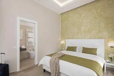 a bedroom with a large bed and a bathroom at St. Peter Fortytwo in Rome