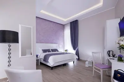 a bedroom with a bed and a table and chairs at St. Peter Fortytwo in Rome