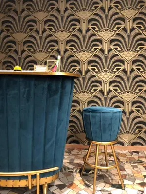 a bar with a blue bench and a wall with wallpaper at Mi Hotel Home in Rome