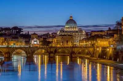 a bridge over a river in front of a building at Mi Hotel Home in Rome