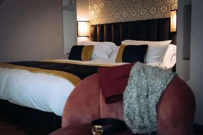 a hotel room with two beds and a chair at Mi Hotel Home in Rome