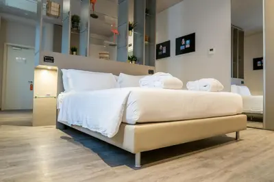 a bedroom with a large bed with towels on it at Hotel San Giovanni Roma in Rome