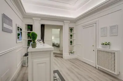 a white room with a fireplace and flowers in it at Charme & Chic Luxury in Rome