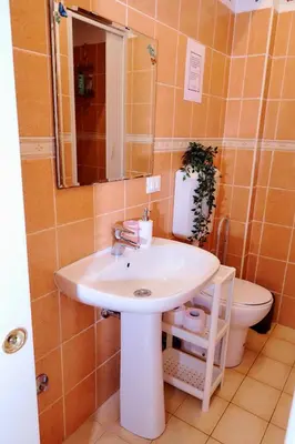 a bathroom with a sink and a toilet at Casa Gaby in Rome