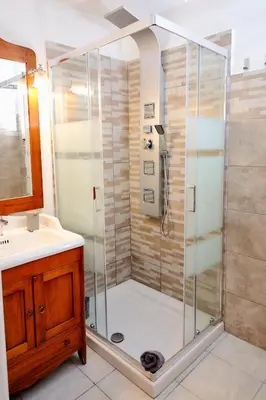 a shower with a glass door in a bathroom at Casa Gaby in Rome