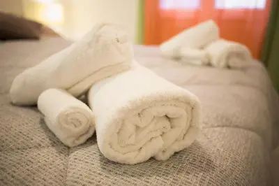 a group of towels sitting on top of a bed at Casa Gaby in Rome
