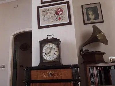a clock on top of a table in a room at The Queen's Coffer Rome in Rome