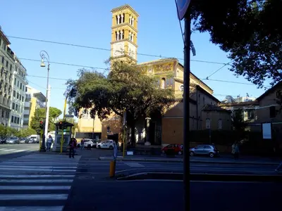 a building with a clock tower on a city street at The Queen's Coffer Rome in Rome