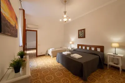 a bedroom with a bed and a living room at Domus Candia in Rome