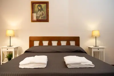 a bedroom with a bed with two towels on it at Domus Candia in Rome