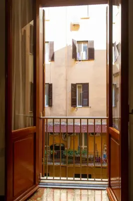 an open door to a balcony with a view of a building at Domus Candia in Rome
