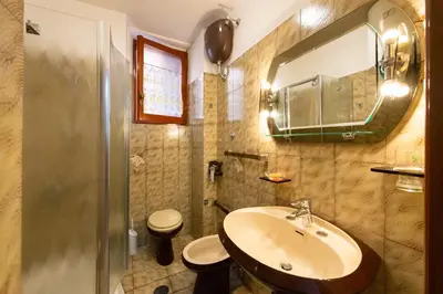 a bathroom with a sink and a toilet and a mirror at Domus Candia in Rome