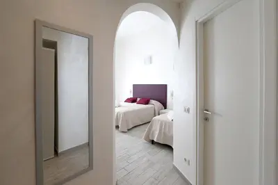 a bedroom with a bed and a mirror in a room at 47 Steps in Rome