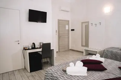 a living room with a bed and a desk and a room at 47 Steps in Rome