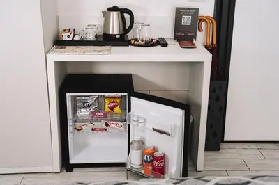 a small refrigerator under a table in a kitchen at 47 Steps in Rome