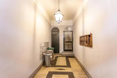 a hallway with a black door and a trash can at Pantheon Unique Rooms in Rome