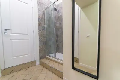 a bathroom with a shower and a mirror at Pantheon Unique Rooms in Rome