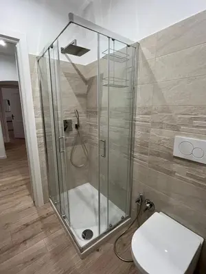 a glass shower in a bathroom with a toilet at Ottaviano Lodge in Rome