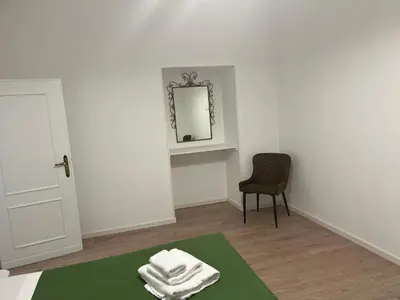 a room with a bed with a mirror and a chair at Ottaviano Lodge in Rome