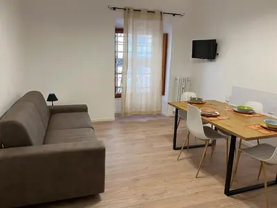 a living room with a couch and a dining room table at Ottaviano Lodge in Rome
