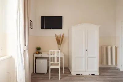 a room with a white desk and a white cabinet at Dante's in Vaticano 2 in Rome