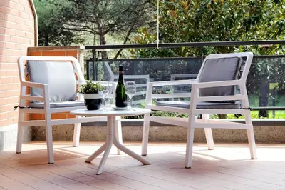 two chairs and a table with a bottle of wine at Aurelia Relax Apartment in Rome