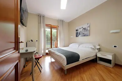 a bedroom with a bed and a desk and a window at Aurelia Relax Apartment in Rome