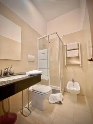 a bathroom with a toilet and a shower and a sink at Termini Palace Guesthouse in Rome