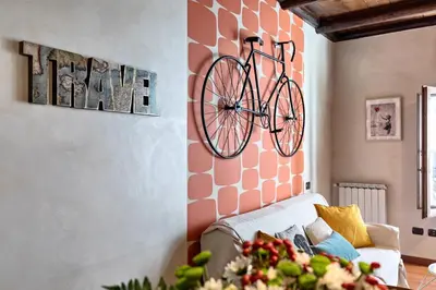 a bike hanging on a wall in a living room at Rome As You Feel - Cancelleria Apartment in Navona in Rome
