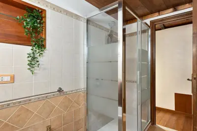 a shower with a glass door in a bathroom at Rome As You Feel - Cancelleria Apartment in Navona in Rome