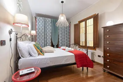 a bedroom with a bed with a red blanket on it at Rome As You Feel - Cancelleria Apartment in Navona in Rome