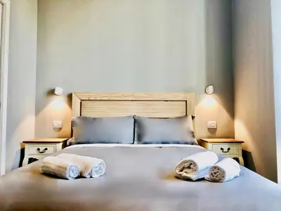 a bedroom with a bed with towels on it at Audrey's Roman Holidays - Rome Suites & Rooms in Rome