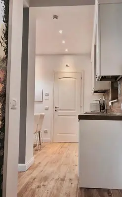 a kitchen with white walls and a white door at Audrey's Roman Holidays - Rome Suites & Rooms in Rome