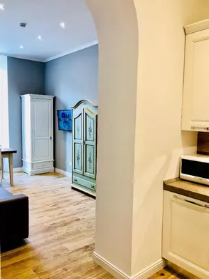 a kitchen with blue walls and a counter top at Audrey's Roman Holidays - Rome Suites & Rooms in Rome