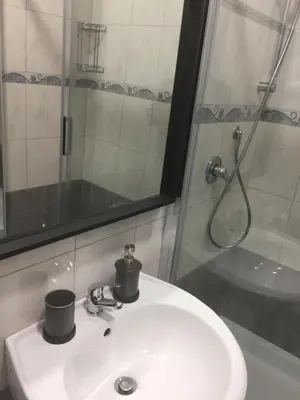 a bathroom sink with two cups on top of it at Bakirooms in Rome