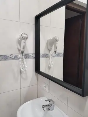 a bathroom with a mirror and a sink at Bakirooms in Rome