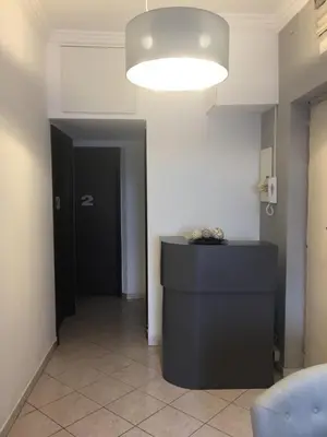 a hallway with a black door and a light at Bakirooms in Rome