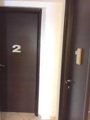 a door with the number in a hallway at Bakirooms in Rome