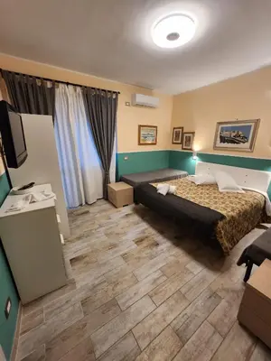 a hotel room with a bed and a flat screen tv at Le terrazze di Alberto in Rome