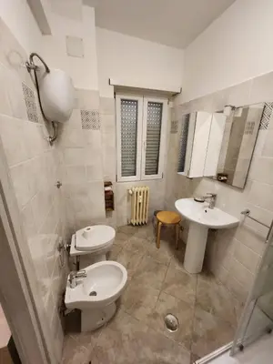 a bathroom with two sinks and a toilet at Le terrazze di Alberto in Rome