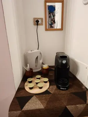 a coffee maker and cupcakes on a cutting board at Le terrazze di Alberto in Rome