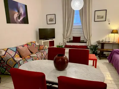 a living room with a table and a couch at Chroma Apt Farinone 28 in Rome