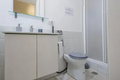 a bathroom with a toilet and a sink and a shower at Chroma Apt Farinone 28 in Rome