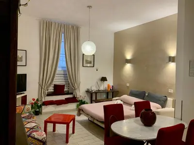 a bedroom with a bed and a table and chairs at Chroma Apt Farinone 28 in Rome