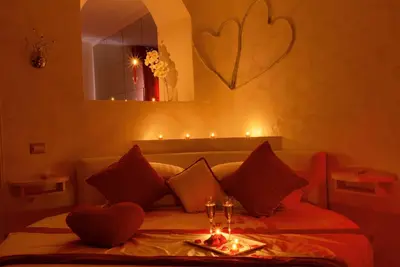 a bedroom with a bed with a table and candles at Ripetta Luxury Del Corso in Rome