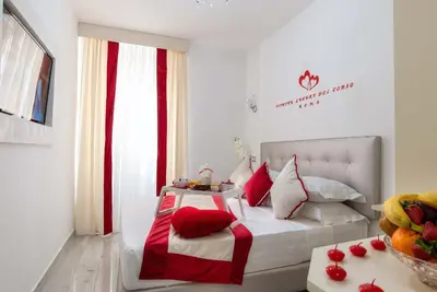 a bedroom with a bed with red and white pillows at Ripetta Luxury Del Corso in Rome