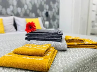 a group of towels sitting on top of a bed at Olympic Suite Roma in Rome