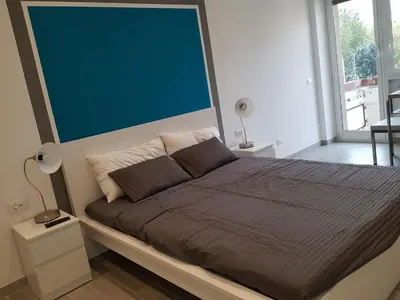 a bedroom with a bed with a large green wall at In Rome Trastevere Rooms in Rome