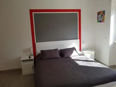 a bed with a large headboard in a bedroom at In Rome Trastevere Rooms in Rome